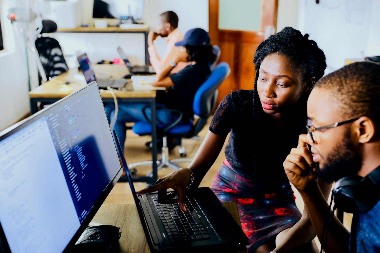 Young people learning together at computers